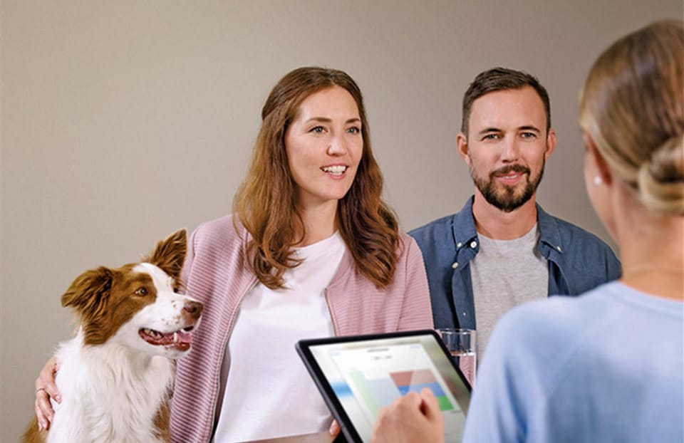 Woman and man with dog in pension consultation Woman and man with dog in pension consultation