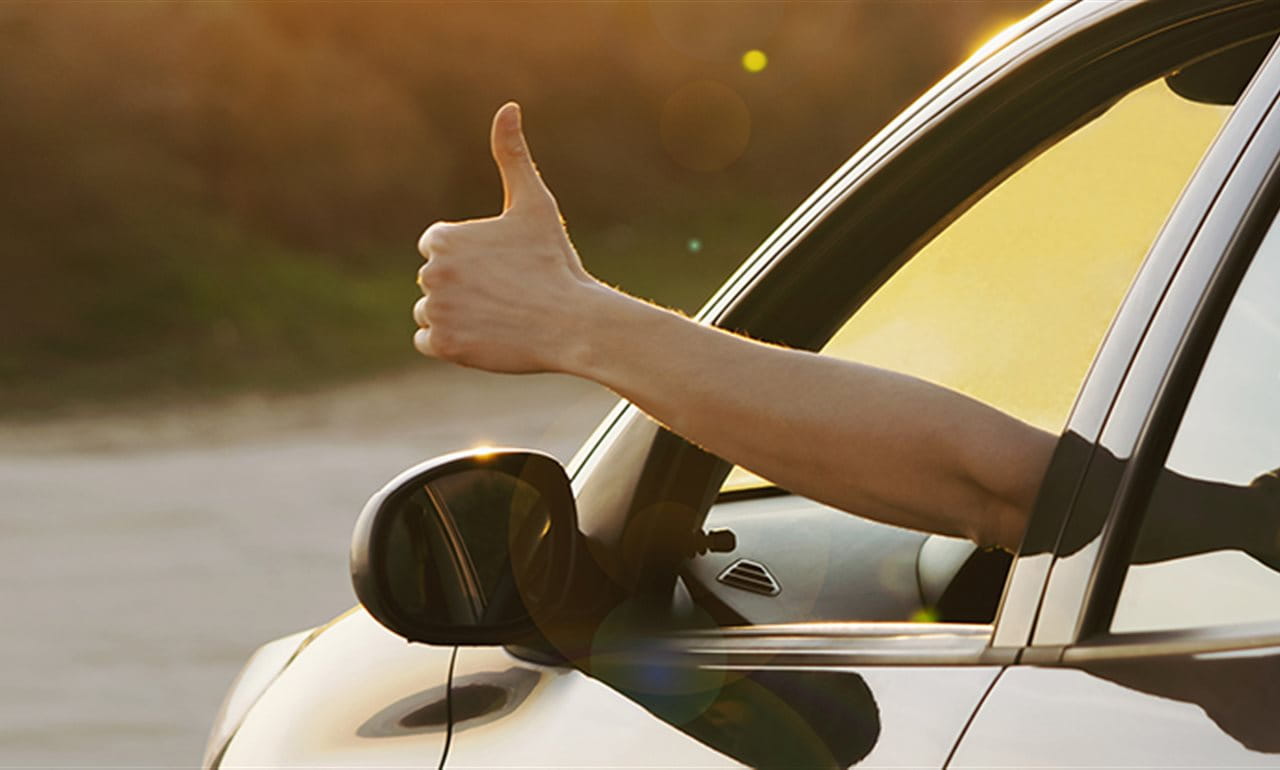 Thumb up from car window Thumb up from car window