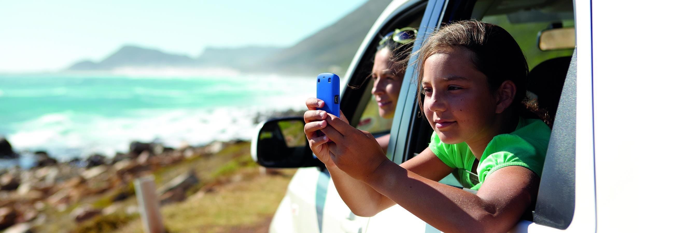 Child with cell phone in the car Child with cell phone in the car