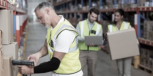 Logistician with a smart elbow wearable scans a parcel Logistician with a smart elbow wearable scans a parcel