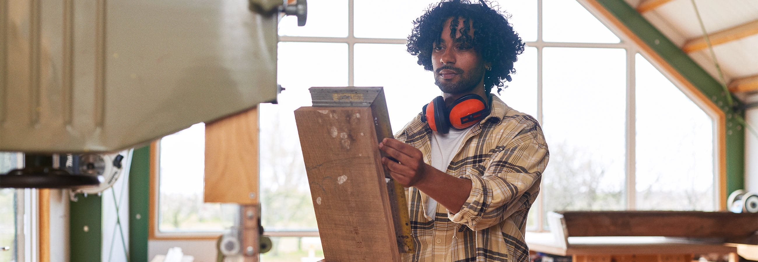 Man works in a carpentry shop Man works in a carpentry shop
