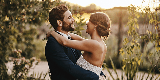 Newlywed couple hugging happily Newlywed couple hugging happily