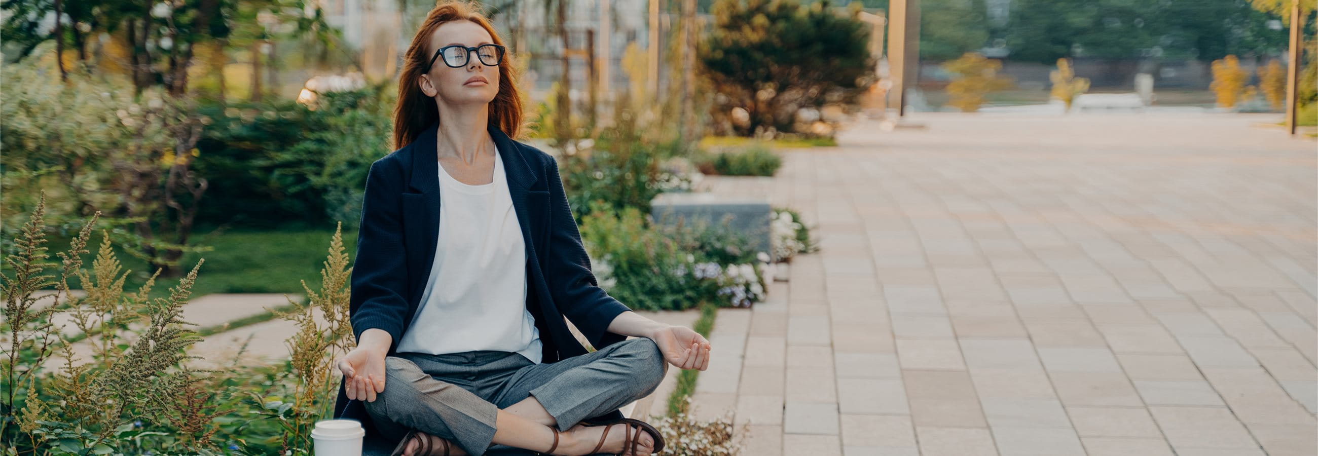 Woman sits in the park and does yoga  Woman sits in the park and does yoga