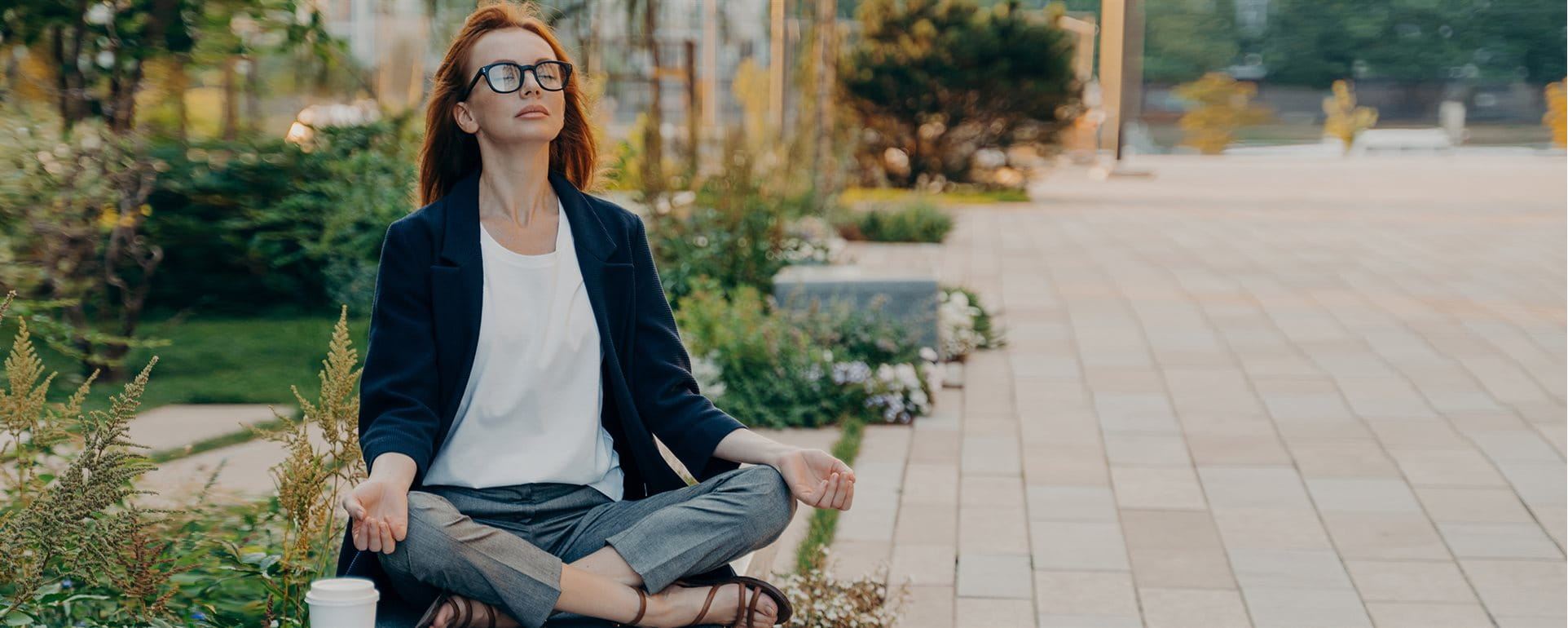 Woman sits in the park and does yoga Woman sits in the park and does yoga