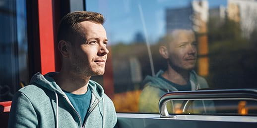Person sitting thoughtfully on public transport, looking out the window. Person sitting thoughtfully on public transport, looking out the window.