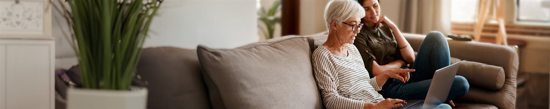 Mother and daughter are looking togehter at a laptop Mother and daughter are looking togehter at a laptop