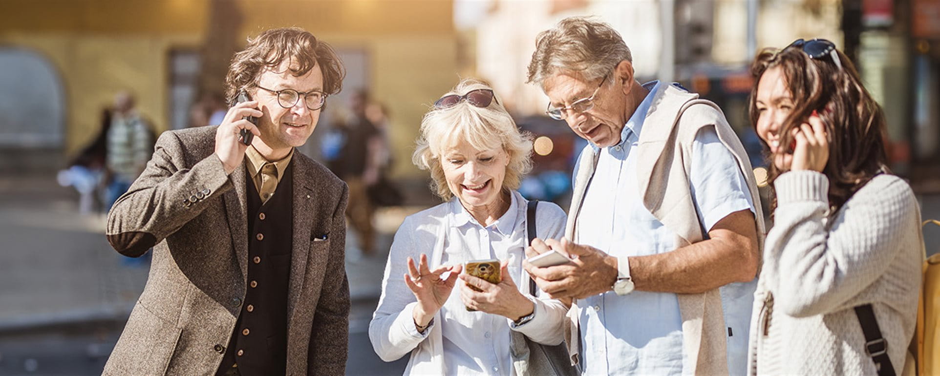 Two couples are on the phone in a city Two couples are on the phone in a city