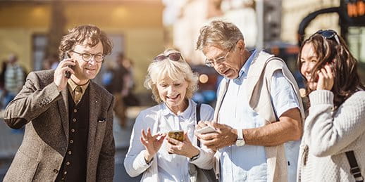 Two couples are on the phone in a city Two couples are on the phone in a city