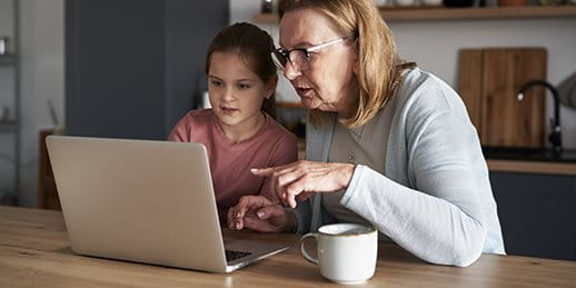 Woman sitting with child at laptop Woman sitting with child at laptop