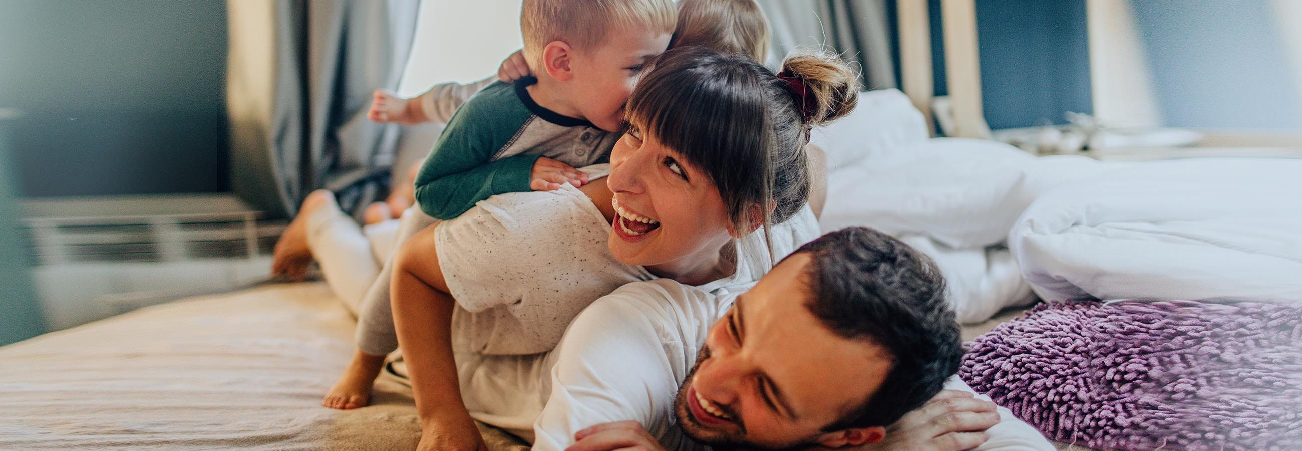 Family enjoying time spent in the bedroom Family enjoying time spent in the bedroom