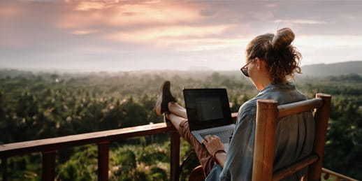 A woman is working with a laptop on the terrace A woman is working with a laptop on the terrace