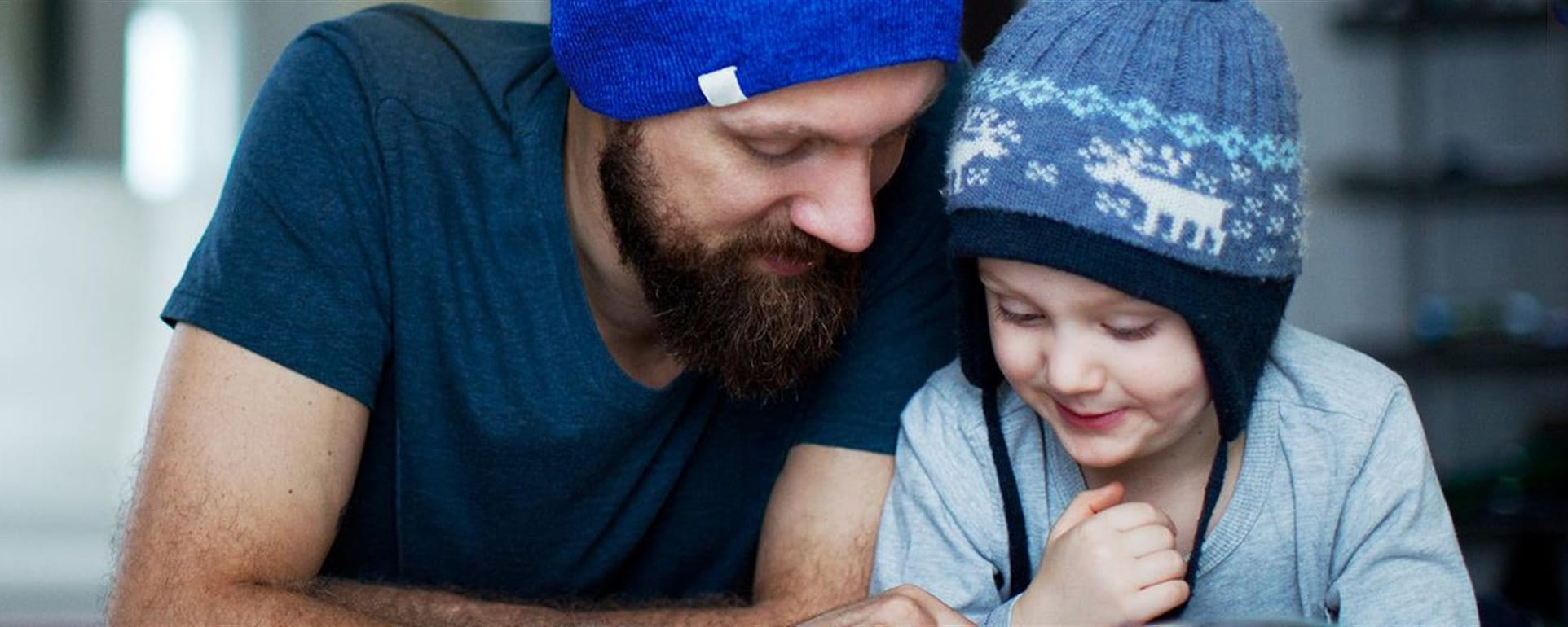 Man reads book with child Man reads book with child