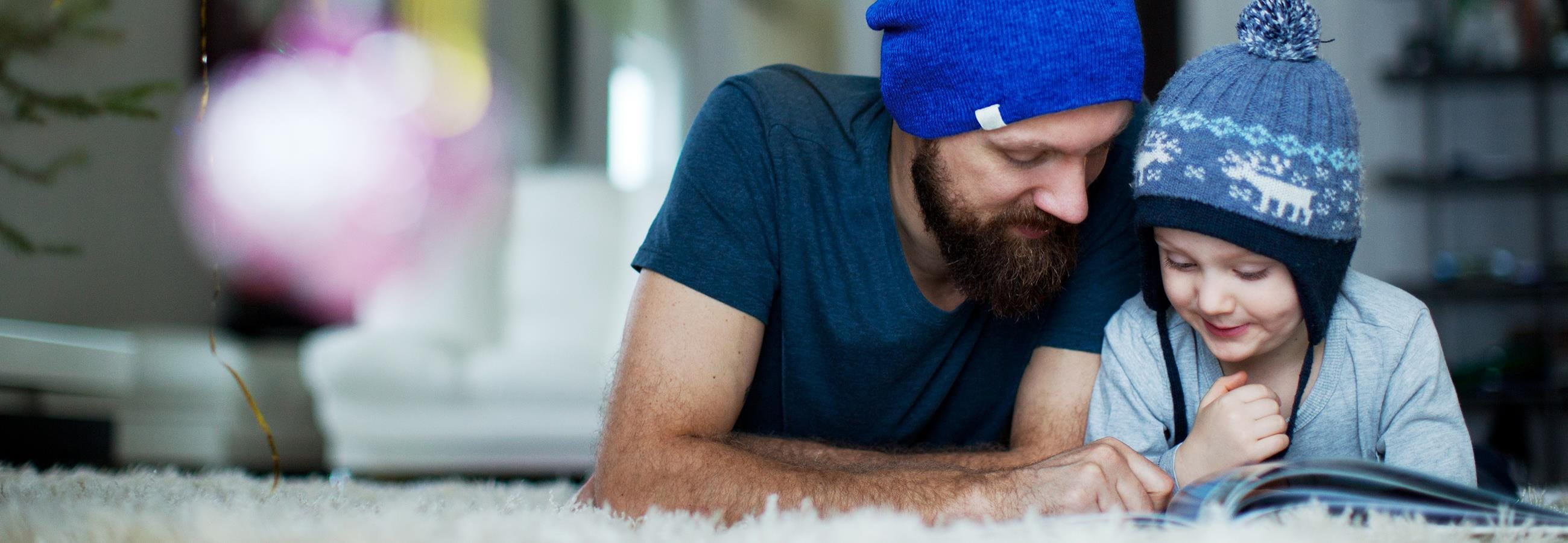 Man reads book with child Man reads book with child