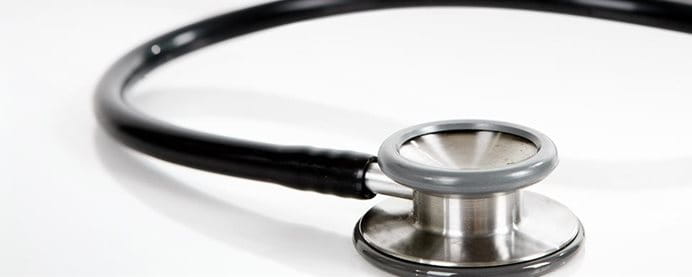 A stethoscope on a table. A stethoscope on a table.