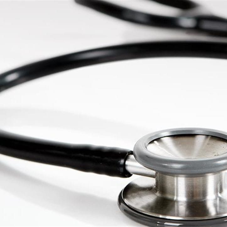 A  stethoscope on a table. A  stethoscope on a table.