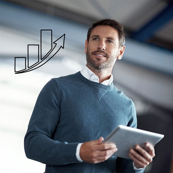 La prévoyance professionnelle pour les entreprises Un homme regarde par une fenêtre sur laquelle est dessiné un bâtiment d’entreprise, et pense à sa prévoyance professionnelle.